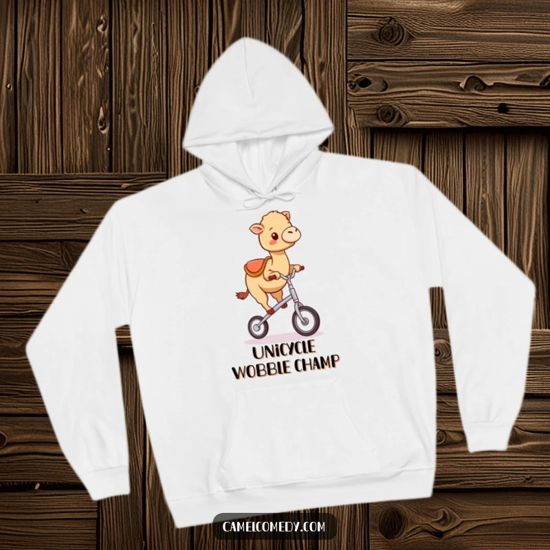 Funny kawaii camel happily wobbling while attempting to ride a tiny unicycle, depicted on a soft and cozy hoodie.
