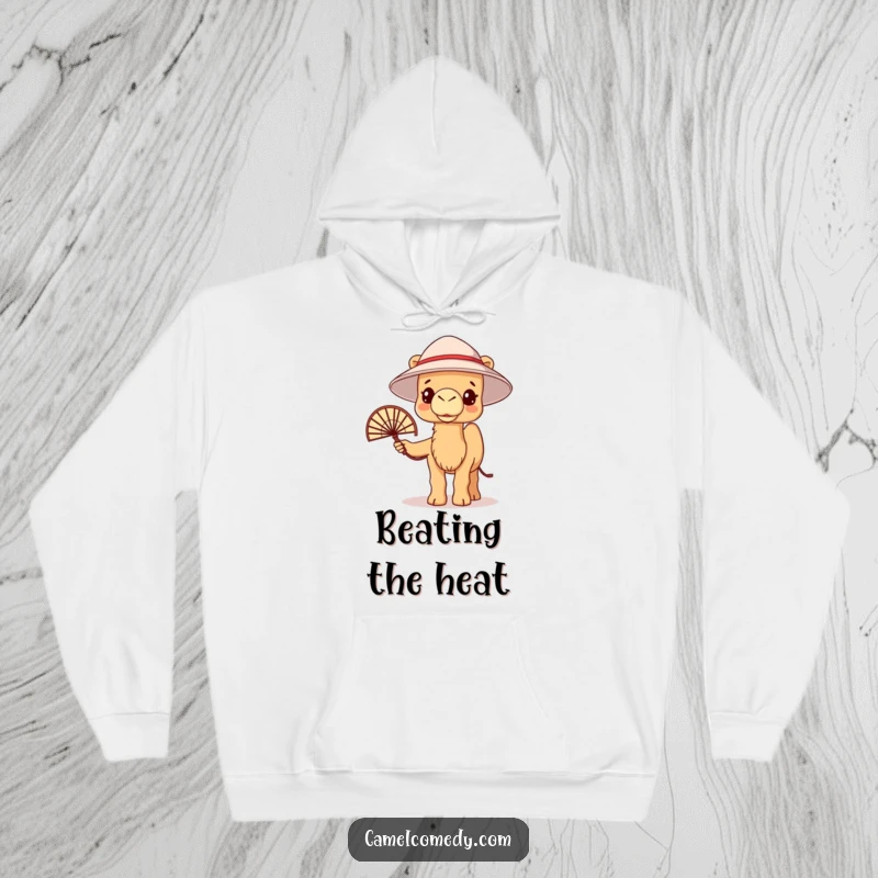 Funny kawaii camel wearing a bucket hat and holding a fan, looking delightfully warm on a cozy hoodie.