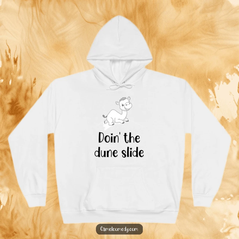 Funny hoodie with a kawaii camel sliding down a sand dune with a big grin, offering warmth and desert humor.
