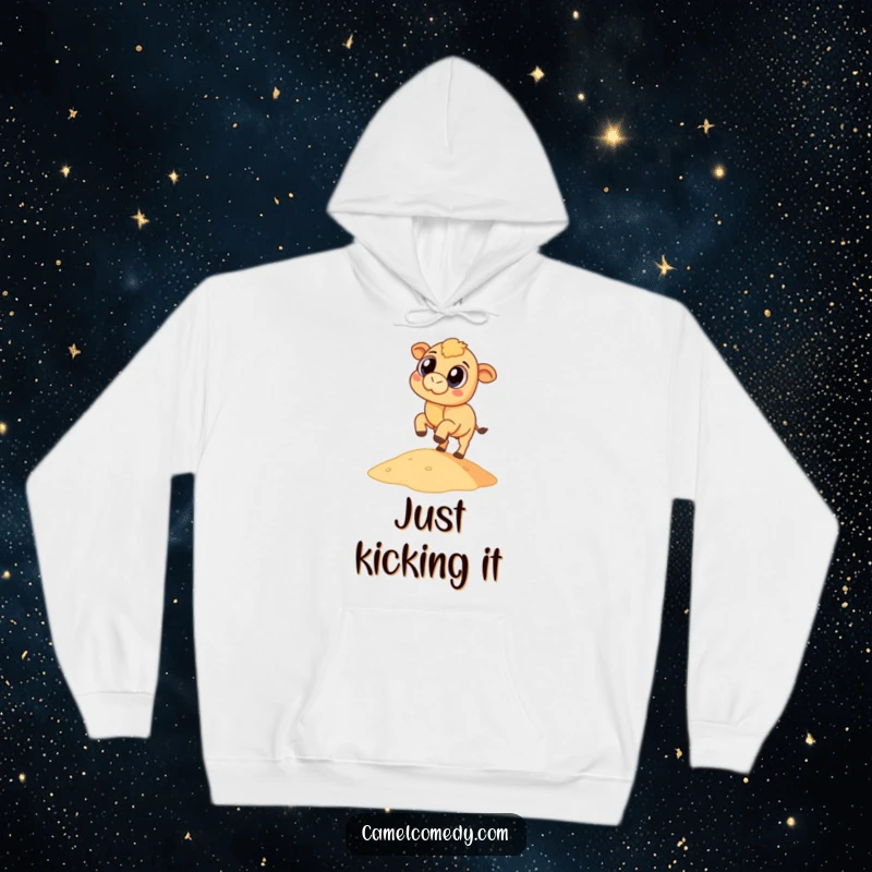 Funny, stocky camel with wide eyes playfully kicking a small sand dune, featured on a warm hoodie.