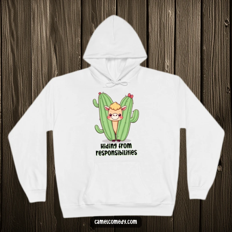 Funny hoodie with a kawaii camel peeking from behind a smiling cactus, offering comfort and a touch of desert humor.