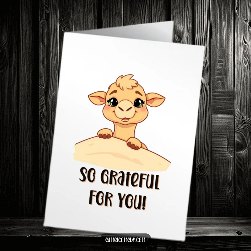 Funny free printable thank you card where a camel with a goofy grin playfully peeks from behind a sand dune.